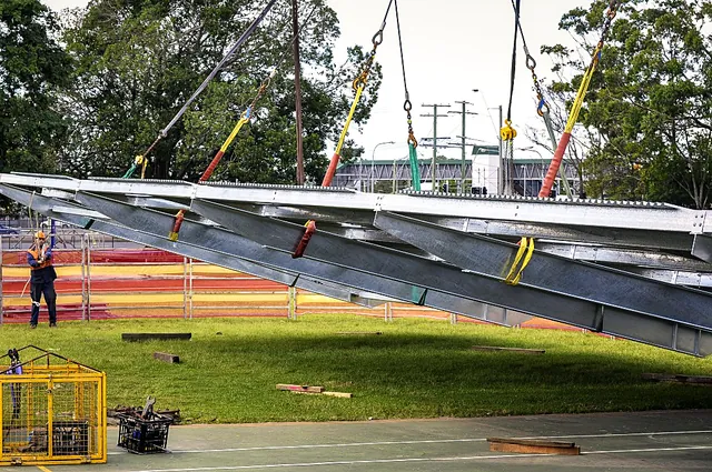 Steel beams rigged with slings and chains
